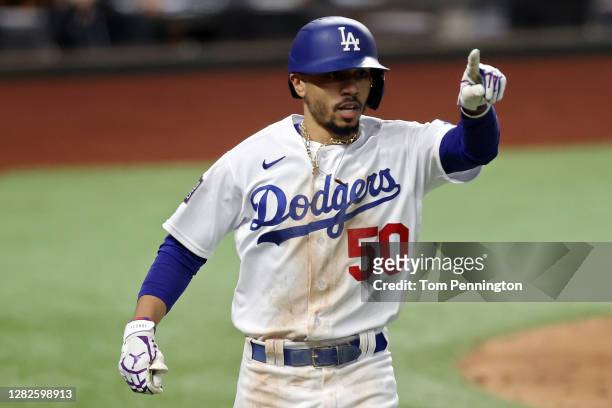 Mookie Betts of the Los Angeles Dodgers celebrates after hitting a solo home run against the Tampa Bay Rays during the eighth inning in Game Six of...