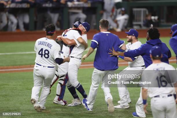 The Los Angeles Dodgers celebrate after defeating the Tampa Bay Rays in Game Six to win the 2020 MLB World Series at Globe Life Field on October 27,...