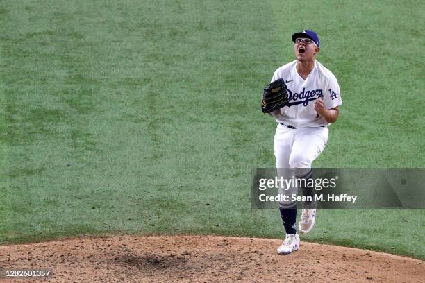 Julio Urias of the Los Angeles Dodgers celebrates after defeating the Tampa Bay Rays 3-1 in Game Six to win the 2020 MLB World Series at Globe Life...