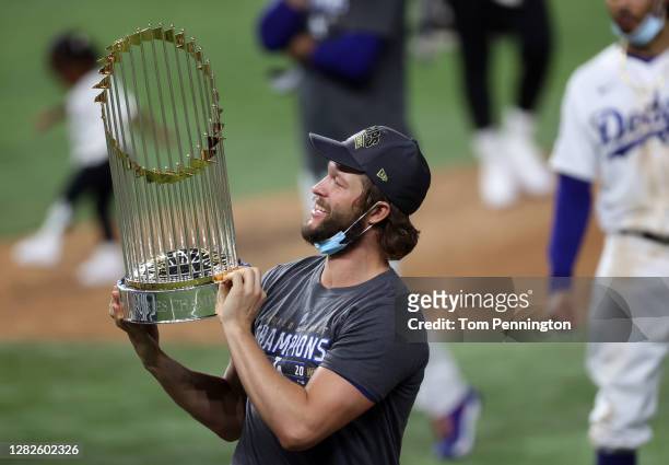 Clayton Kershaw of the Los Angeles Dodgers celebrates with the Commissioners Trophy after defeating the Tampa Bay Rays 3-1 in Game Six to win the...