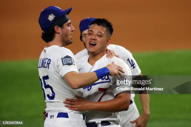 Cody Bellinger of the Los Angeles Dodgers celebrates with Julio Urias and Joe Kelly after defeating the Tampa Bay Rays 3-1 in Game Six to win the...