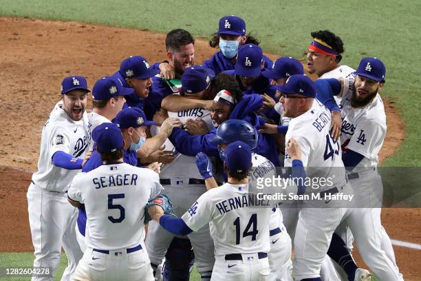 The Los Angeles Dodgers celebrate after defeating the Tampa Bay Rays 3-1 in Game Six to win the 2020 MLB World Series at Globe Life Field on October...