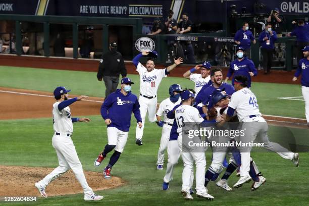 The Los Angeles Dodgers celebrate after defeating the Tampa Bay Rays 3-1 in Game Six to win the 2020 MLB World Series at Globe Life Field on October...