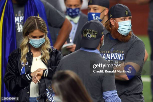 Justin Turner of the Los Angeles Dodgers and his wife Kourtney Pogue, look on after the teams 3-1 victory against the Tampa Bay Rays in Game Six to...