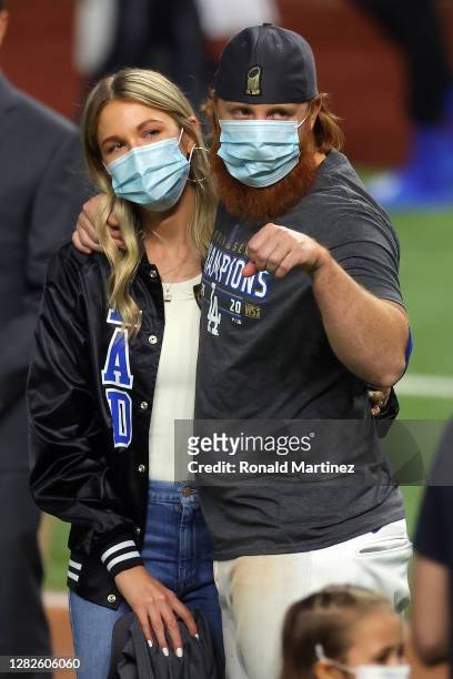 Justin Turner of the Los Angeles Dodgers and his wife Kourtney Pogue, look on after the teams 3-1 victory against the Tampa Bay Rays in Game Six to...