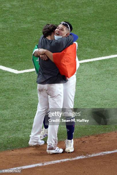Julio Urías of the Los Angeles Dodgers celebrates with Enrique Hernandez after defeating the Tampa Bay Rays 3-1 in Game Six to win the 2020 MLB World...