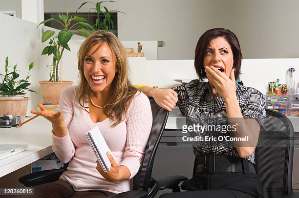 two employees in office cubicle - yawn office stock pictures, royalty-free photos & images