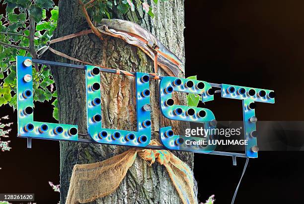 lust on a light-sign on a tree - eversofine stock-fotos und bilder