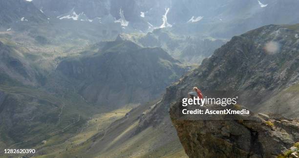 female hiker relaxes on mountain ridge - leading edge stock pictures, royalty-free photos & images