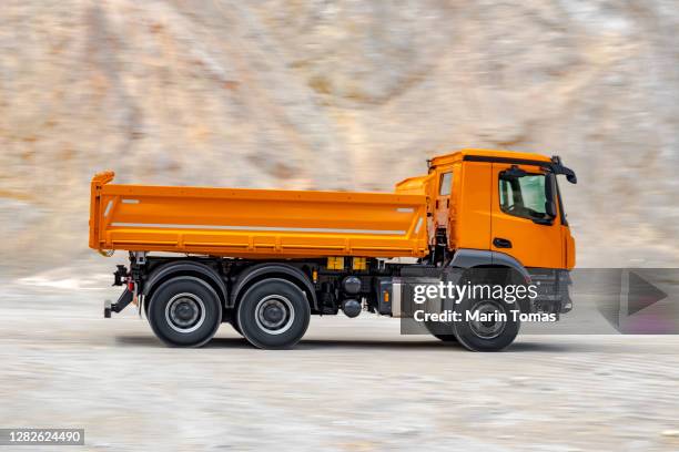 dumper truck driving - camión de descarga fotografías e imágenes de stock