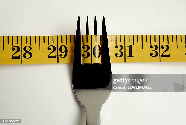 close-up of fork with measuring tape - eversofine stock pictures, royalty-free photos & images