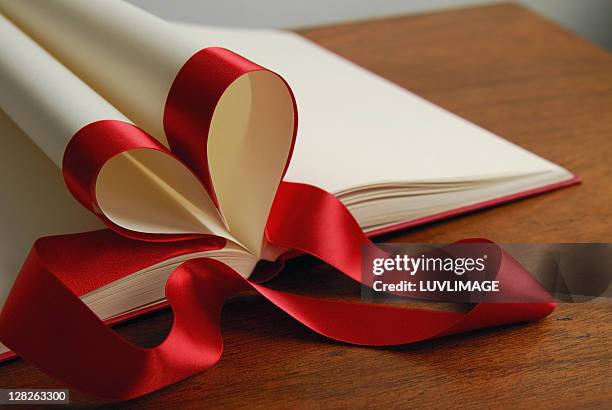 red heart folded out of a dummy-book - eversofine stock pictures, royalty-free photos & images