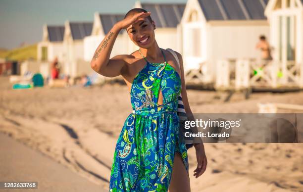 beautiful mixed race woman wearing a long dress on the beach - woman long dress beach stock pictures, royalty-free photos & images