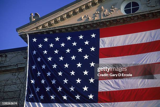 detail of huge american flag hung on a town hall entrance, waltham, ma. - national flag stock pictures, royalty-free photos & images