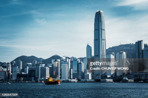 skyline of victoria harbour on hong kong island from kowloon, hong kong - ifc stock pictures, royalty-free photos & images
