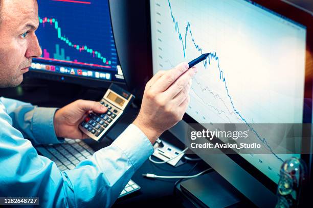 stockbroker analyzes the financial chart - financial analyst stock pictures, royalty-free photos & images