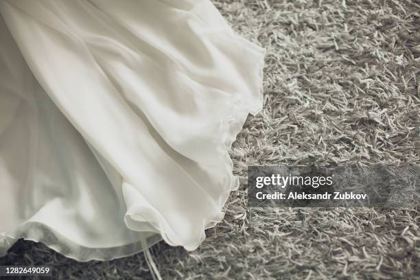 the hem of the white wedding openwork silk expensive luxury bride's dress. copy of the space. - 裾 ストックフォトと画像