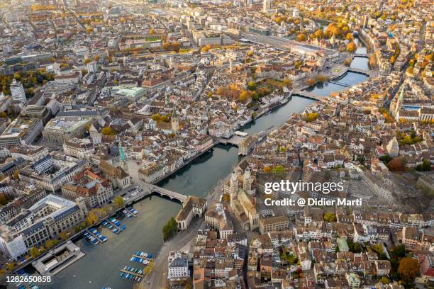 aerial view of sunset over zurich old town along the limmat river with the grossmunster cathedral - zürich bildbanksfoton och bilder