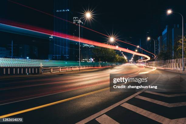 dalian cbd at night - city lights reflected on buildings speed stock pictures, royalty-free photos & images