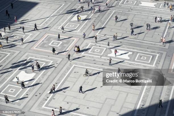 people walking on piazza del duomo, milan, italy - milan photos et images de collection