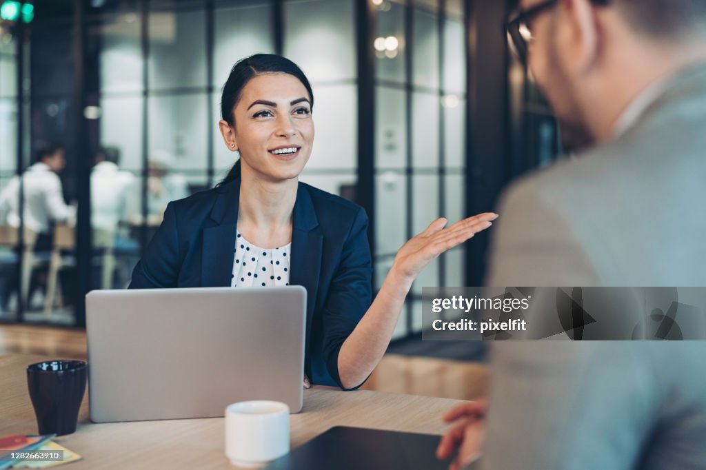 Businesswoman talking to a colleague