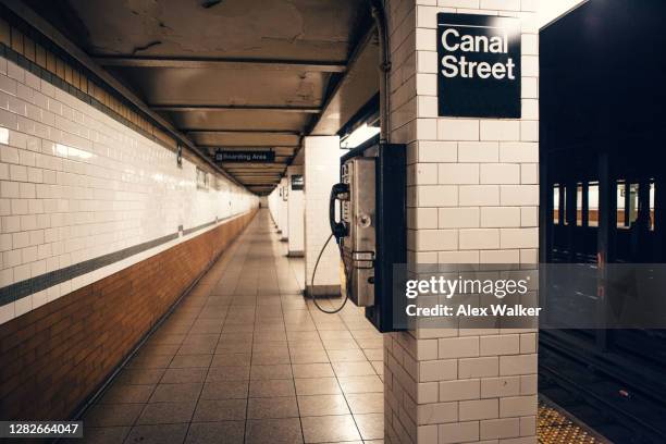 pay phone on empty subway station platform - underground walkway stock pictures, royalty-free photos & images