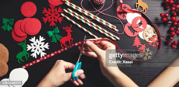 creative christmas preparation for decoration - child cutting card stock pictures, royalty-free photos & images