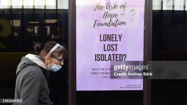 Woman is seen walking past a charity called Ark of Hope Foundation, as Staffordshire prepares to move into Tier 2 COVID-19 on October 28, 2020 in...