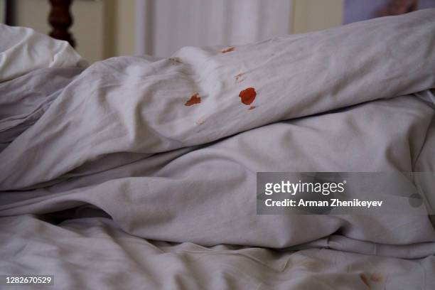 blood spots on grey linen bedding - period blood stockfoto's en -beelden