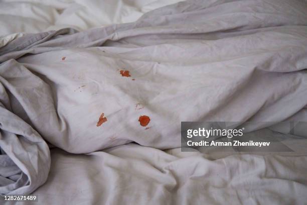 blood spots on grey linen bedding - period blood foto e immagini stock