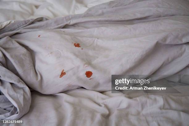 blood spots on grey linen bedding - period blood stockfoto's en -beelden