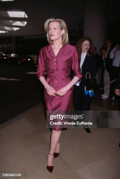 American actress Kim Basinger, wearing a burgundy coloured dress, attends the 70th Annual Academy Awards Nominees Luncheon, held at the Beverly...