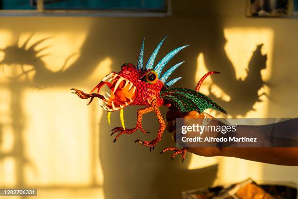 David Linares shows an alebrije during a day of work at David Linares Studio on October 27, 2020 in Mexico City, Mexico. David Linares is a Mexican...