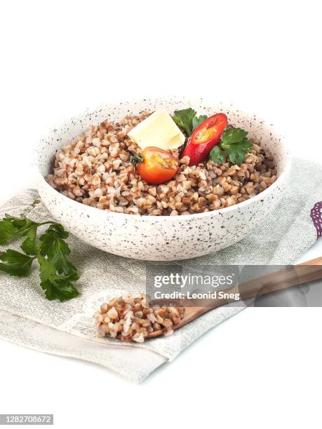 food photography of diet buckwheat cereal porridge with vegetables side view on a white background isolated - buckwheat stock pictures, royalty-free photos & images