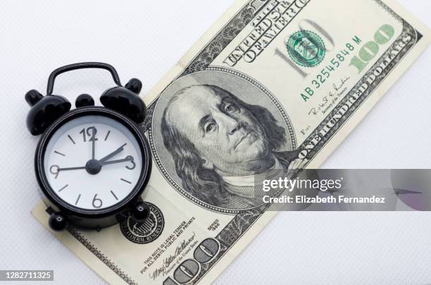 vintage alarm clock over us one hundred dollar bill, top view - countdown 100 stock pictures, royalty-free photos & images