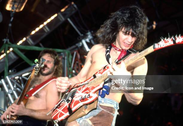 American musician, songwriter, producer, and inventor Eddie Van Halen plays his custom Steinberger guitar at Cobo Arena during Van Halen's "1984...