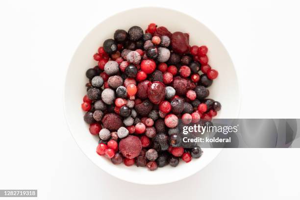 frozen berry mix in white bowl - wolfberry stock pictures, royalty-free photos & images