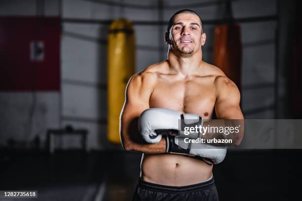 muscular kickboxer showing muscles - fighter portraits stock pictures, royalty-free photos & images