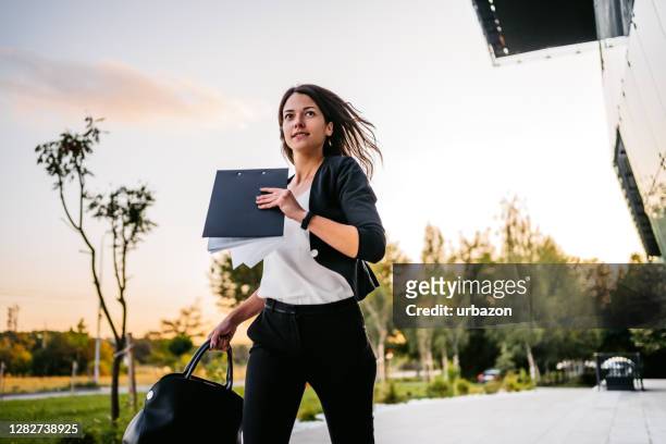 businesswoman running late in office - hurry stock pictures, royalty-free photos & images