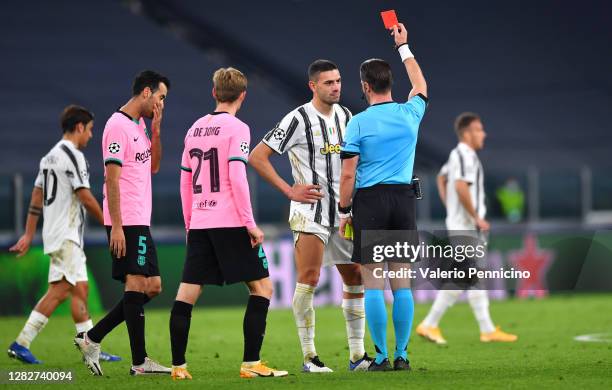 Merih Demiral of Juventus is shown a red card by referee Danny Makkelie after receiving a second yellow card during the UEFA Champions League Group G...