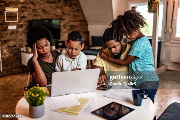 frustrated african american family doing home finances. - worried family stock pictures, royalty-free photos & images