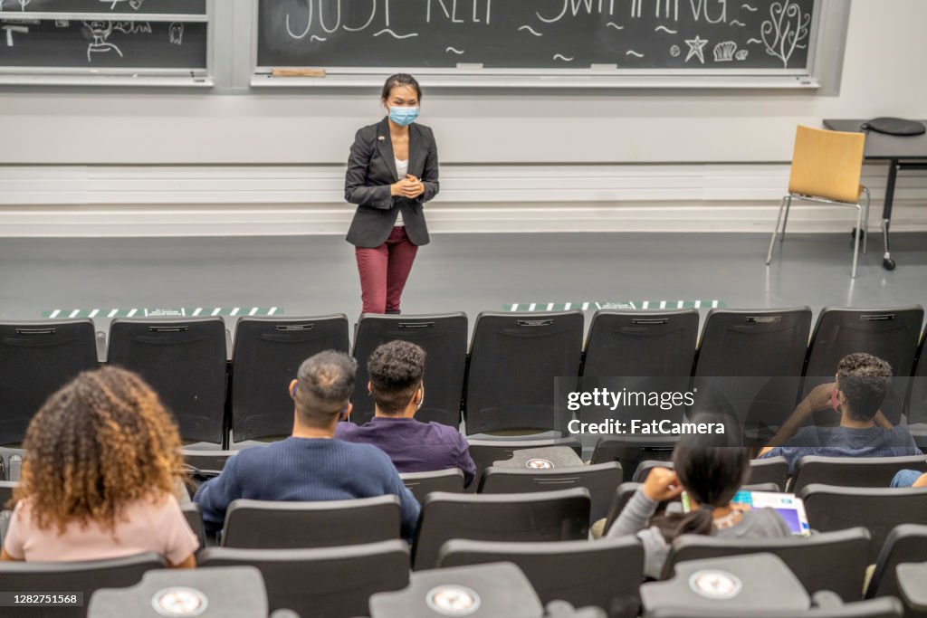 Professor wearing a mask while teaching a lecture