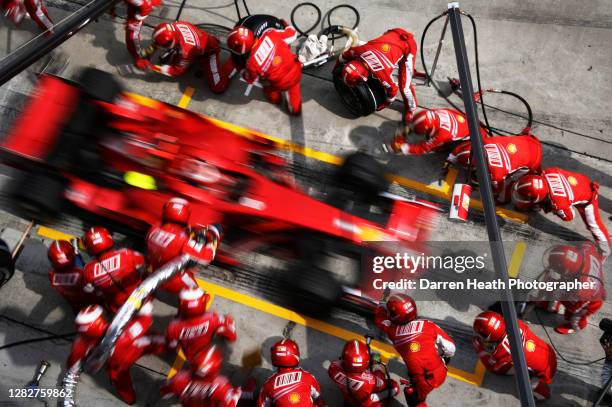 Finnish Ferrari Formula One driver Kimi Raikkonen drives his Ferrari F2008 racing car in to the Ferrari pit stop box where his mechanics are ready to...