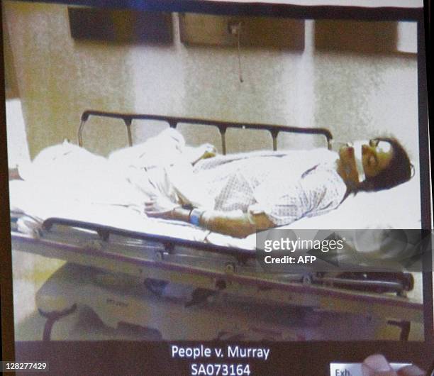 Pop star Michael Jackson lies dead on a gurney as deputy district attorney David Walgren speaks in this evidence photo projection at Dr. Conrad...