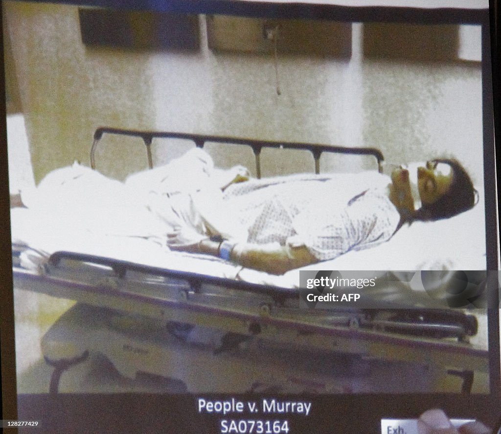 Pop star Michael Jackson lies dead on a gurney as deputy district