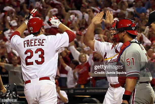 David Freese of the St. Louis Cardinals celebrates with teammate Matt Holliday after Freese hits a two-run home run in the sixth inning off pitcher...