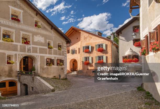 village street with typical houses, mountain village guarda, inn valley, lower engadine, engadine, grisons, switzerland - mountain village stock pictures, royalty-free photos & images