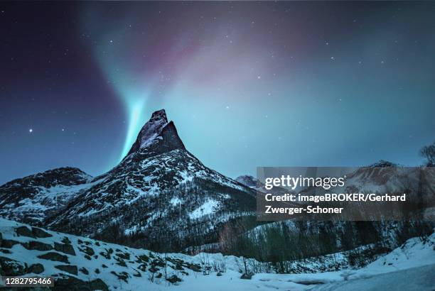 mountain peak (aurora borealis) stetind, arctic winter landscape, night view, starry sky, northern lights northern lights, stetinden, nordland, norway - stetind stock pictures, royalty-free photos & images