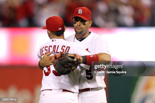 Albert Pujols hugs Daniel Descalso of the St. Louis Cardinals after the Cardinals 5-3 victory against the Philadelphia Phillies in Game Four of the...