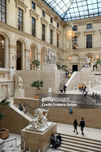 The Louvre Pyramid , designed by the architect I. M. Pei, surrounded by three smaller pyramids, in the main courtyard of the Louvre Palace in Paris...